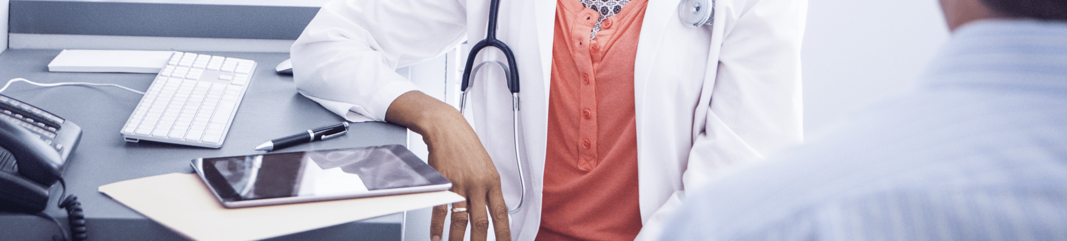 doctor with tablet talking to patient